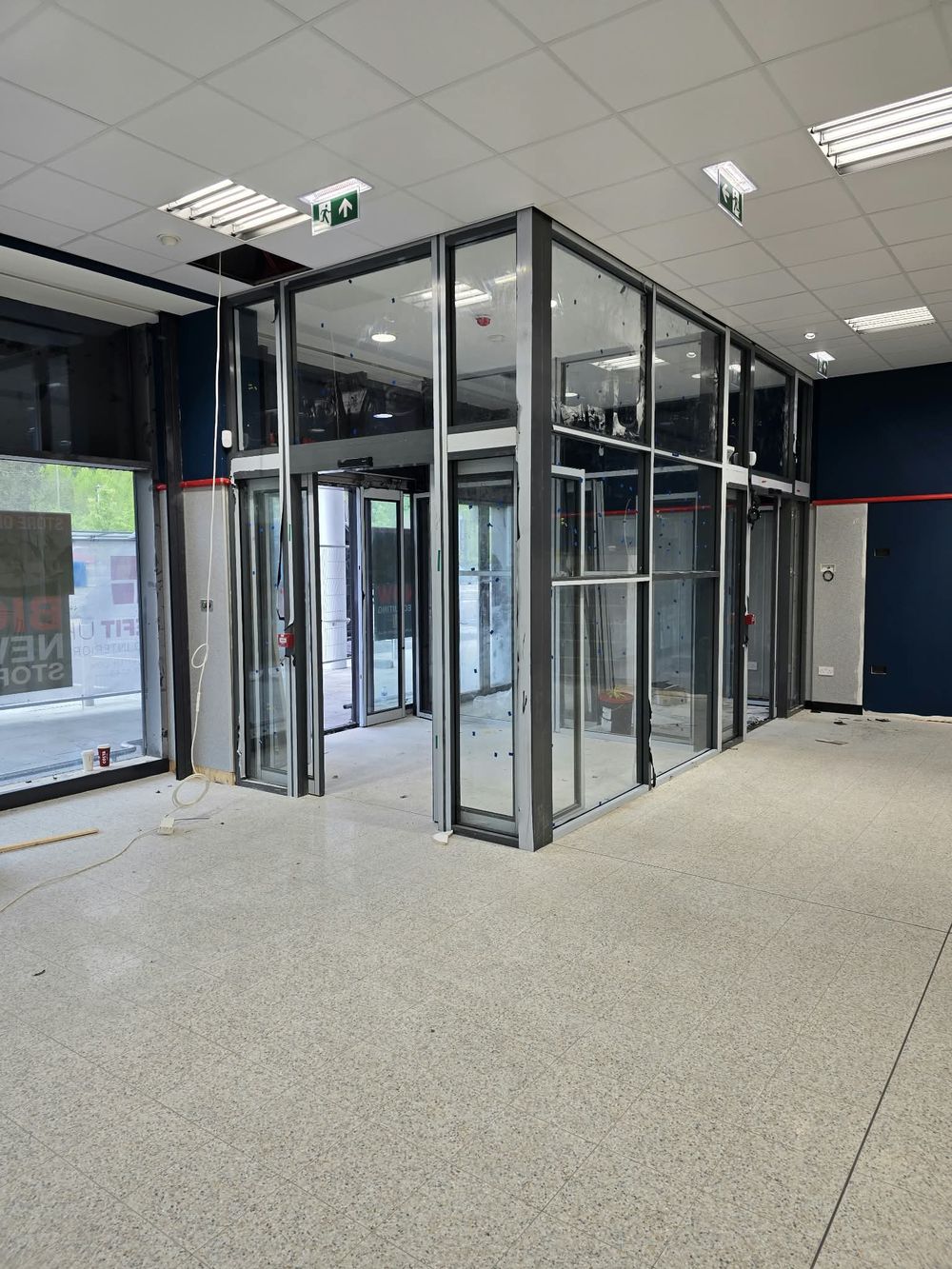 Glazed aluminium entrance lobby inside a retail store